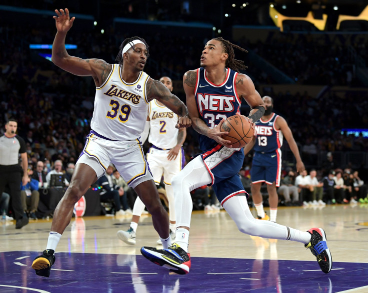 Dwight Howard #39 of the Los Angeles Lakers guards Nic Claxton #33 of the Brooklyn Nets