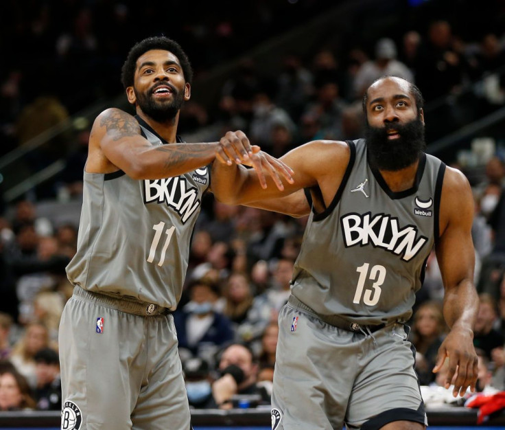 Kyrie Irving #11 of the Brooklyn Nets jokes with James Harden #13 of the Brooklyn Nets