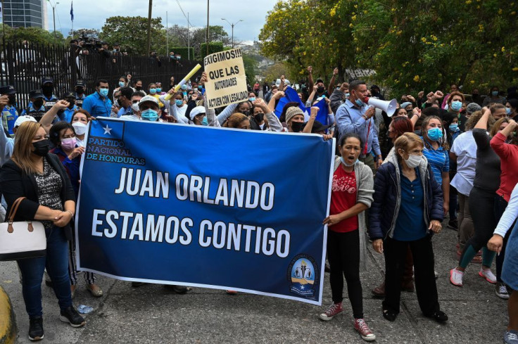 Supporters of former President Juan Orlando Hernandez shout slogans