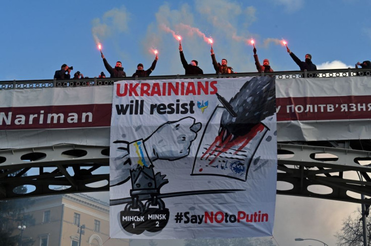 Demonstrators carry banners saying 'Ukranians will resist - Say No to Putin' 