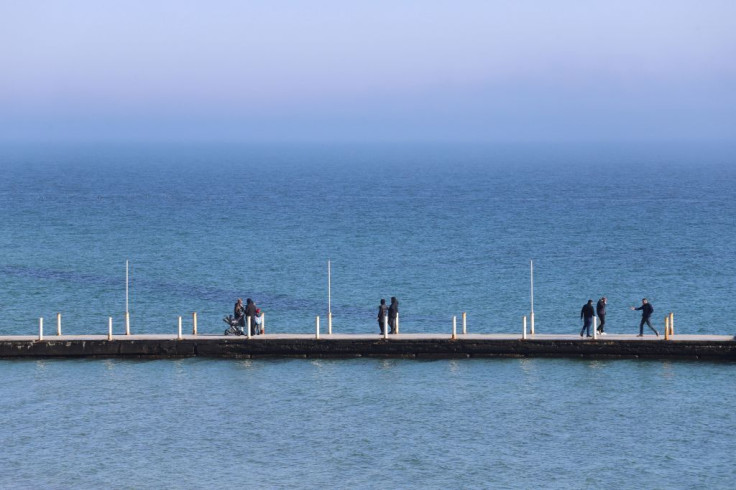 People walk on a pier in Ukrainian Black Sea city of Odessa