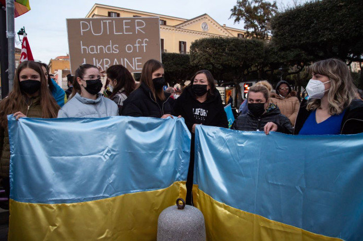 Demonstrators hold Ukrainian flags as they gather during a protest