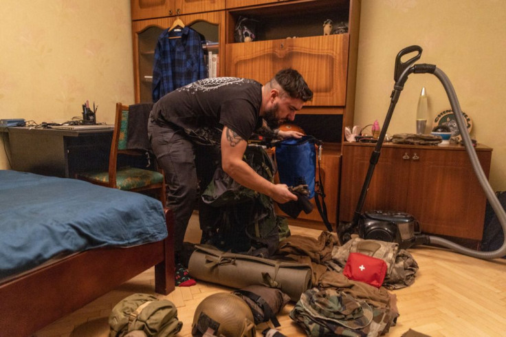 A reservist packs his military equipment 
