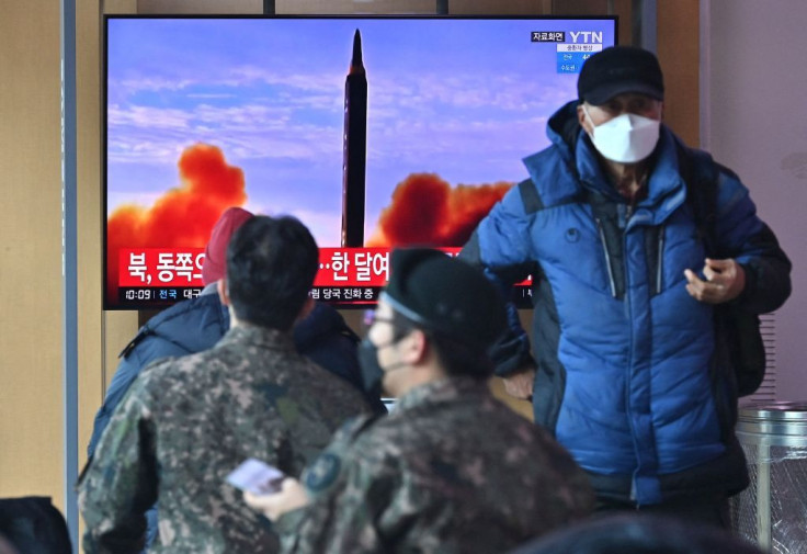 Television screen shows a news broadcast with file footage of a North Korean missile test