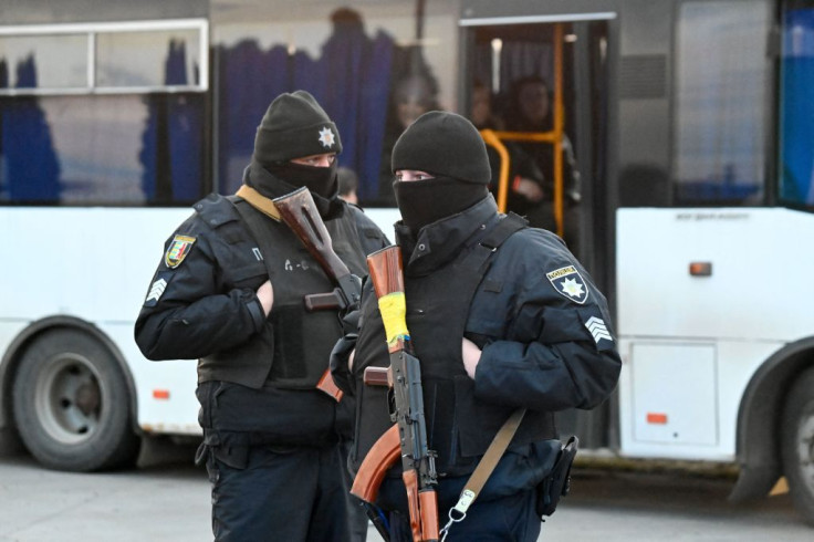 Members of a Ukrainian police unit stand guard in Solomonovo village, Ukraine