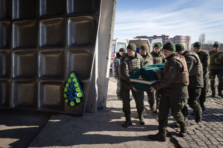 Members of the honor guard carry the coffin of Roman, a member of the Ukrainian military who was killed in recent fighting on the outskirts of Kyiv during his funeral service on March 15, 2022 in Kyiv, Ukraine. 