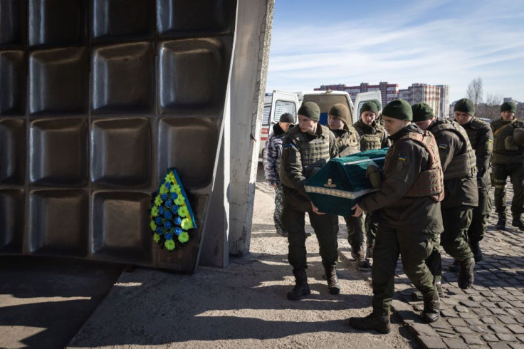 Members of the honor guard carry the coffin of Roman, a member of the Ukrainian military who was killed in recent fighting on the outskirts of Kyiv during his funeral service on March 15, 2022 in Kyiv, Ukraine.