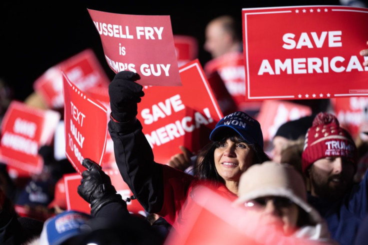 A woman holds a sign for House of Representatives candidate Russell Fry during a rally with former U.S. President Donald Trump at the Florence Regional Airport on March 12, 2022 in Florence, South Carolina. 