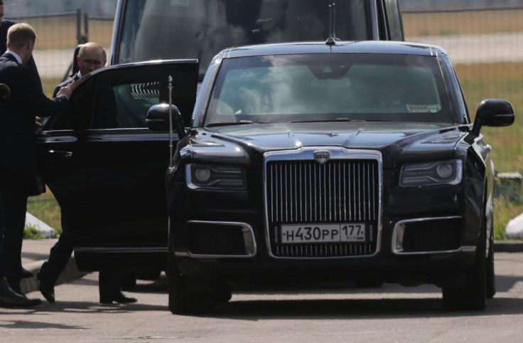 Russian President Vladimir Putin gets into his Aurus limousine