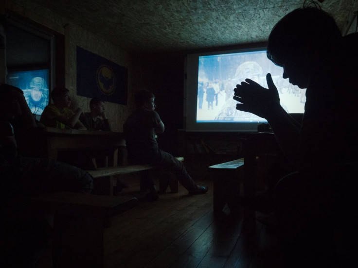 Teenagers, look at a video about the history of the ongoing war in the Donbass at the Haidamatska Sich on February 19, 2022 in Skole, Ukraine.