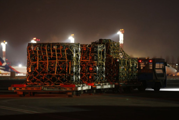 An airport vehicle pulls a portion of a shipment of weapons that include Javelin anti-tank missiles and other military hardware delivered on a National Airlines plane by the United States military at Boryspil Airport near Kyiv
