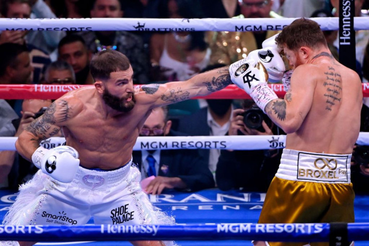 Caleb Plant (L) punches Canelo Alvarez