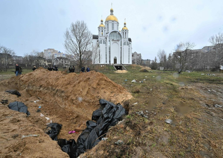 A mass grave is seen behind a church in the town of Bucha, northwest of the Ukrainian capital Kyiv on April 3, 2022.