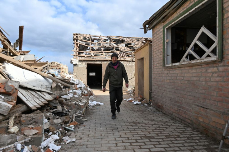 A man walks near his house destroyed as a result of Russian troops shelling 