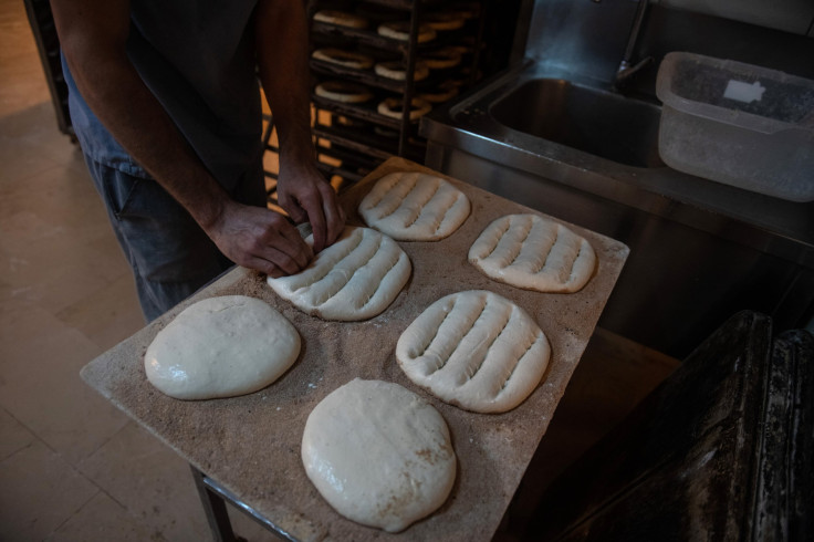 An employee prepares bread dough before baking at a bakery 