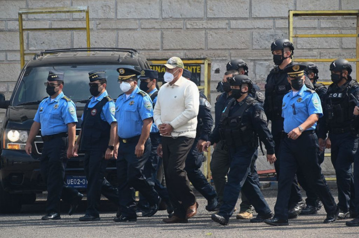 National police and special forces officers escort the former chief of the Honduran police, Juan Carlos Bonilla