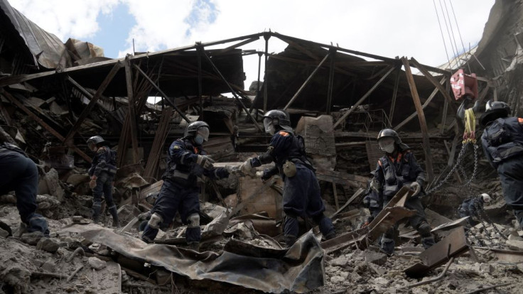 Russian Emergencies personnel clear debris in the partially destroyed Mariupol drama theatre in the city of Mariupol on May 10, 2022, amid the ongoing Russian military action in Ukraine. 
