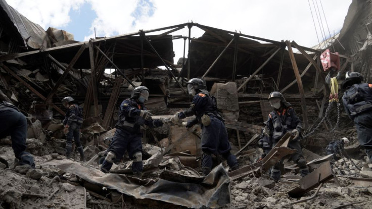 Russian Emergencies personnel clear debris in the partially destroyed Mariupol drama theatre in the city of Mariupol on May 10, 2022, amid the ongoing Russian military action in Ukraine.