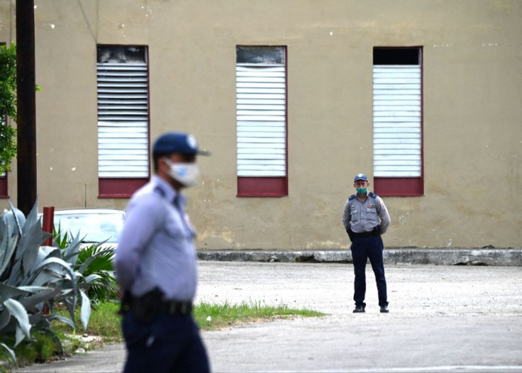 Police officers guard the entrance to the Marianao Municipal Court in Havana
