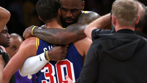  LeBron James #6 of the Los Angeles Lakers hugs Stephen Curry #30 of the Golden State Warriors