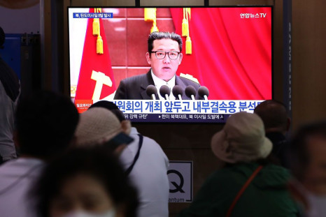 People watch a television broadcast showing a file image of a North Korean leader Kim Jong-Un