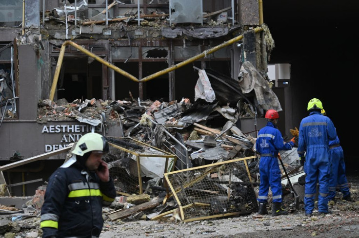 Ukrainian rescuers work outside a damaged residential building hit by Russian missiles in Kyiv on June 26, 2022, amid Russian invasion of Ukraine.