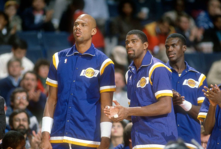 Kareem Abdul-Jabbar #33, Magic Johnson #32 and Orlando Woolridge #0 of the Los Angeles Lakers