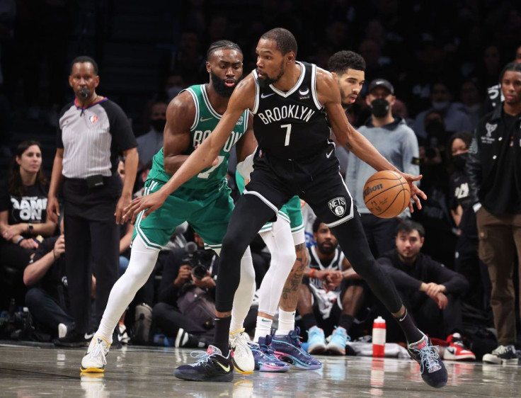 Kevin Durant #7 of the Brooklyn Nets dribbles against Jaylen Brown #7 of the Boston Celtics