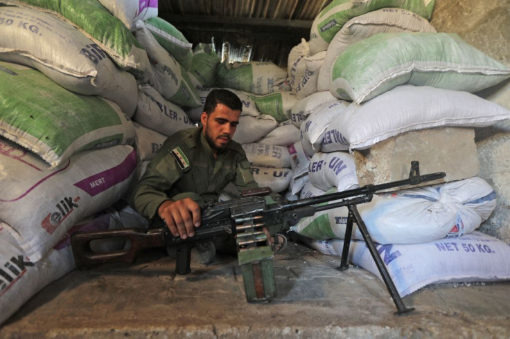 A Turkey-backed fighter mans a military position in the Syrian area of Jibrin