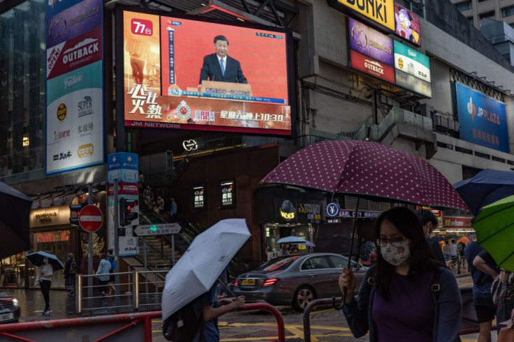 Chinese President Xi Jinping speaks during a news conference, displayed on a television screen