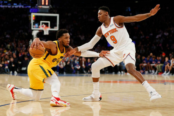 Donovan Mitchell #45 of the Utah Jazz dribbles against RJ Barrett #9 of the New York Knicks