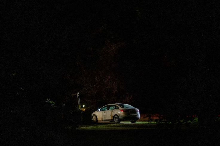 A vehicle sits outside the house where one of the stabbing victims was found on Central Street in Weldon, Saskatchewan