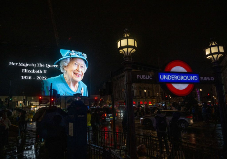 The advertising screens in Piccadilly Circus display an image of Queen Elizabeth II 