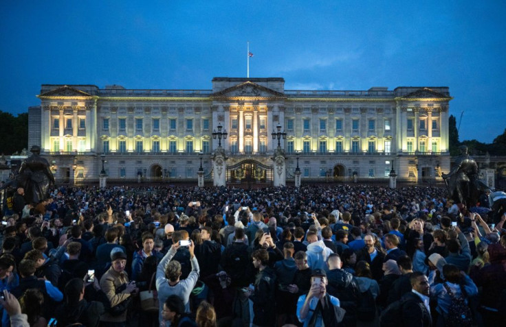 The Union flag flies half-mast as people gather at Buckingham Palace