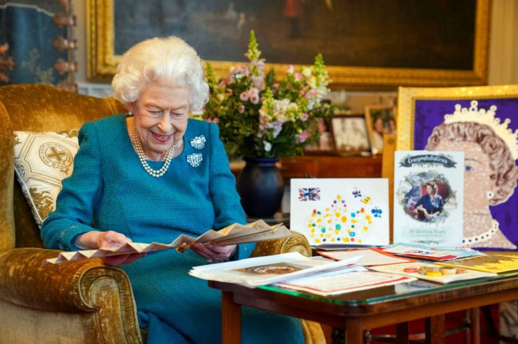 Queen Elizabeth II looking at Queen Victoria's Autograph fan