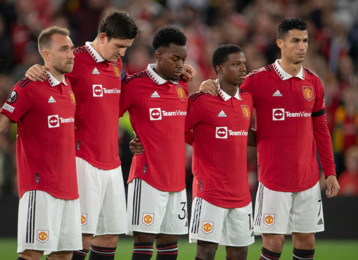 Manchester United players observe a minutes silence following the death of Queen Elizabeth II