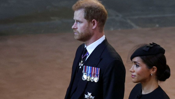 Prince Harry and Meghan walk as procession with the coffin of Britain's Queen Elizabeth arrives at Westminster Hall 