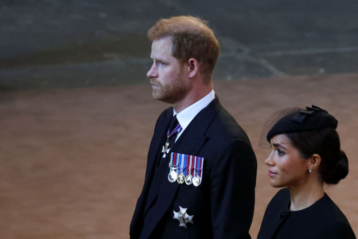 Prince Harry and Meghan walk as procession with the coffin of Britain's Queen Elizabeth arrives at Westminster Hall