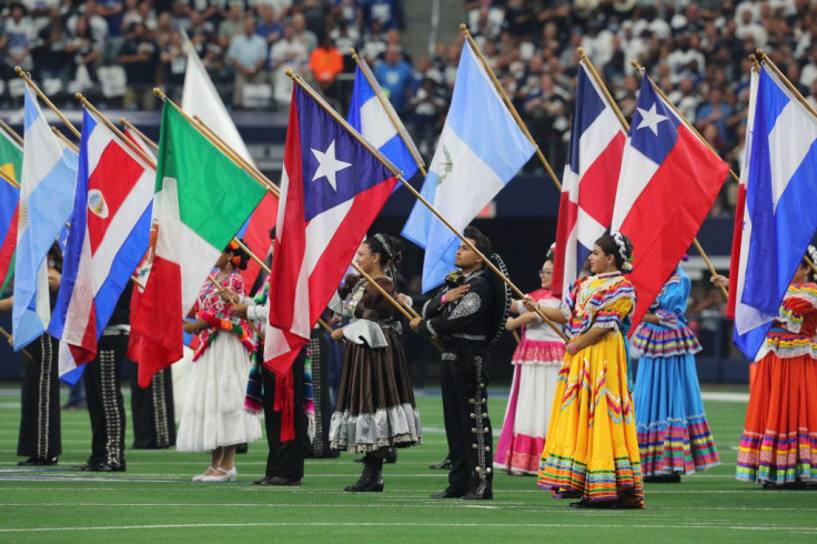 Flags are displayed during the national anthem in honor of Hispanic Heritage Month 2021