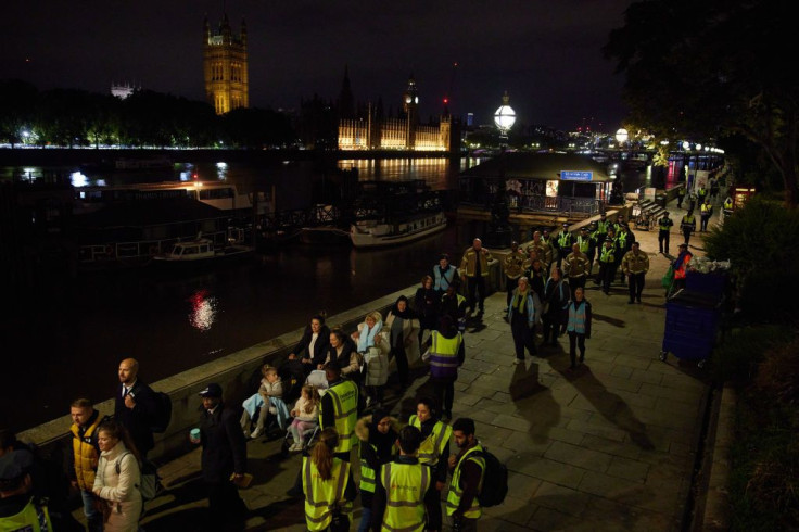 The final participants of a days-long queue passes along the South Bank to pay respect to Queen Elizabeth II