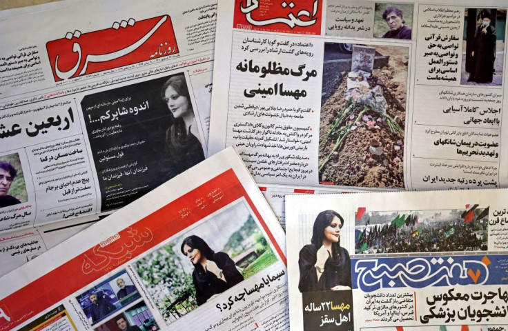 The front pages of Iranian newspapers featuring articles and photographs of Mahsa Amini