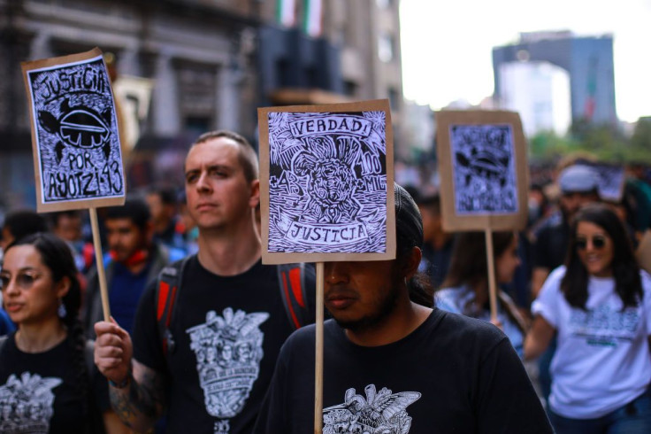 Demonstrator holds a banner during a demonstration to commemorate the 8th anniversary of the disappearance of the Ayotzinapa students