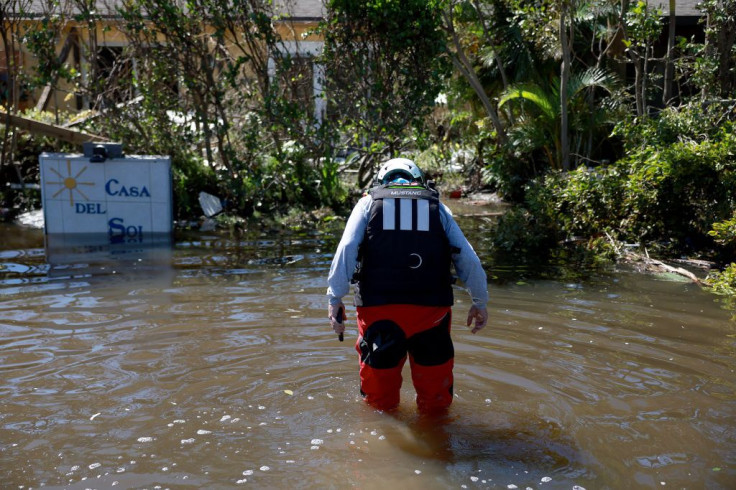 A member of the Texas A&M Task Force 1 Search and Rescue team looks for anyone needing help after Hurricane Ian passed through the area