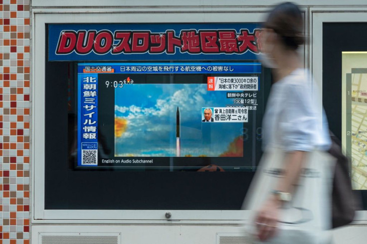 Tv screen displays file footage of North Korean missile launches during a broadcast