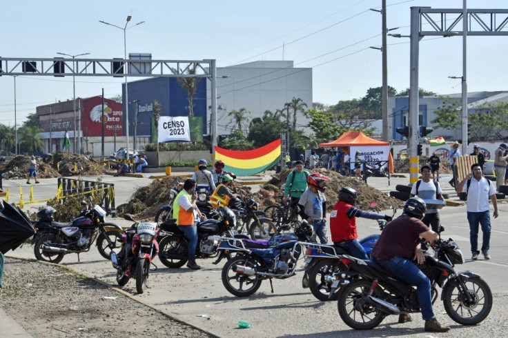 People block a street during an indefinite strike hold by unions opposing the government of Bolivian President Luis Arce
