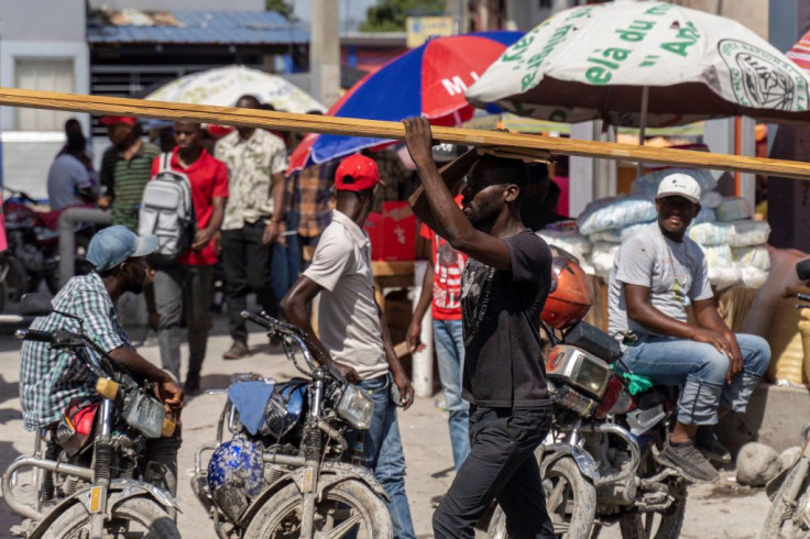 Haitians work in Port-au-Prince on October 29, 2022, one day after gunmen assassinated former presidential candidate Eric Jean Baptiste