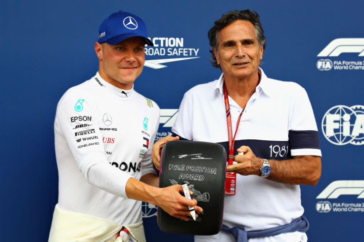 Pole position qualifier Valtteri Bottas of Finland presented that trophy by former F1 World Drivers Champion Nelson Piquet