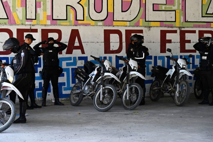 Members of the National Police prepare before going out to patrol the streets of Duran