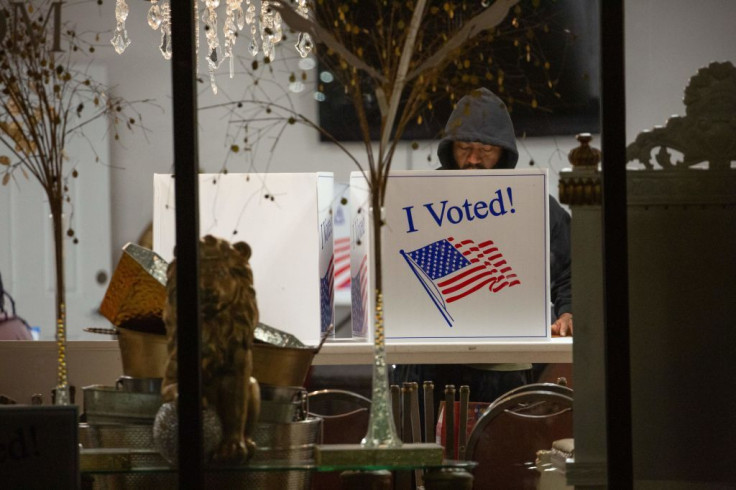 A voter casts his ballot inside a polling place at Elevationz