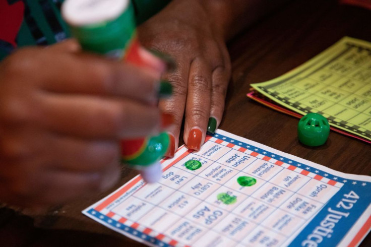 Joy Evans plays election-themed Bingo during an election night watch party